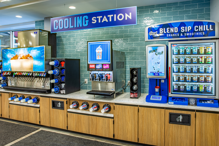 Bright and clean APlus Grind coffee bar featuring bean dispensers, hot drink machines, and tea options, designed for convenience store customers to serve themselves quickly and efficiently