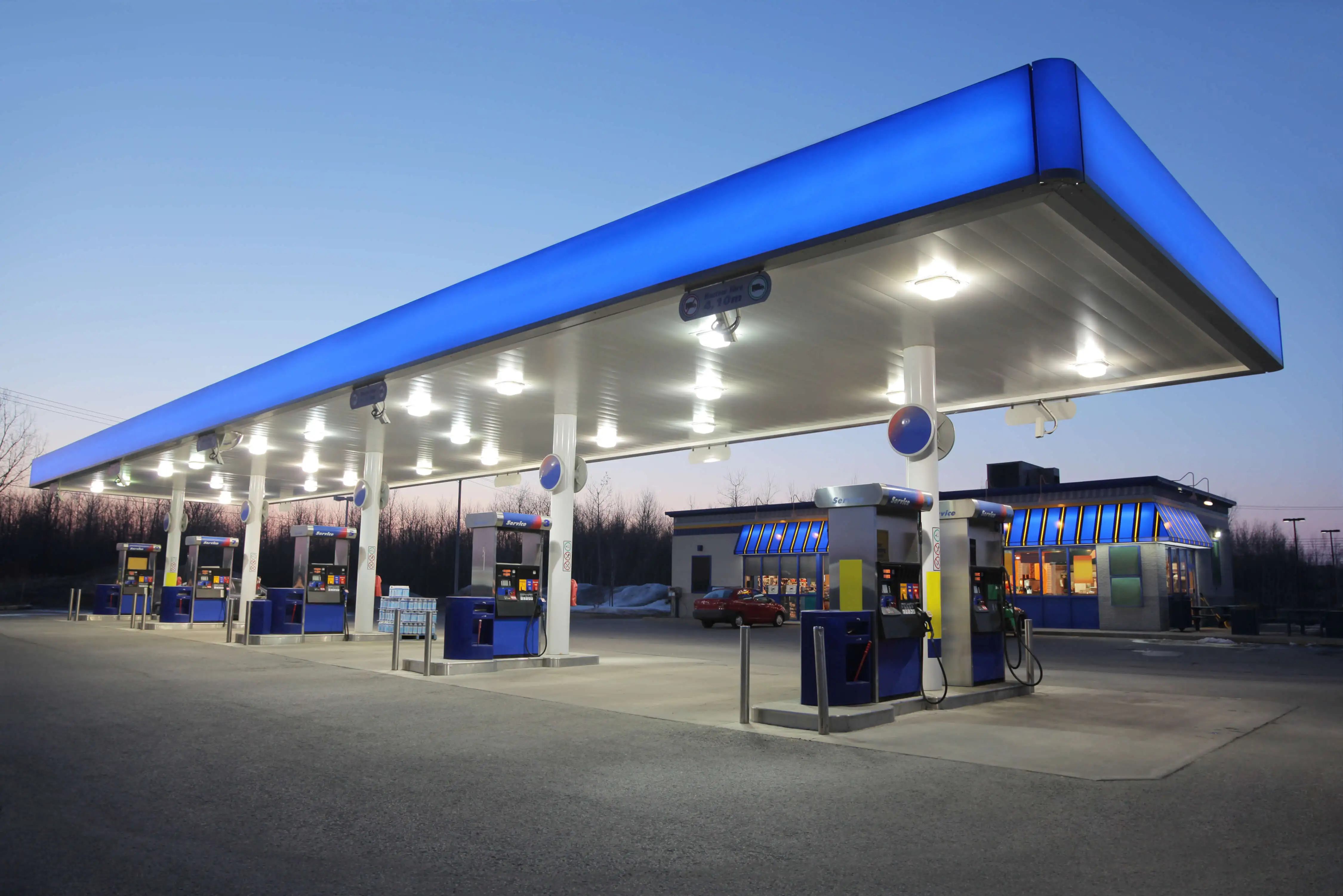 Illuminated Gas Station at Sunset