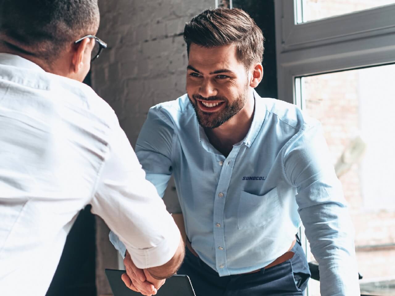 Man with SunocoLP shirt shaking hands